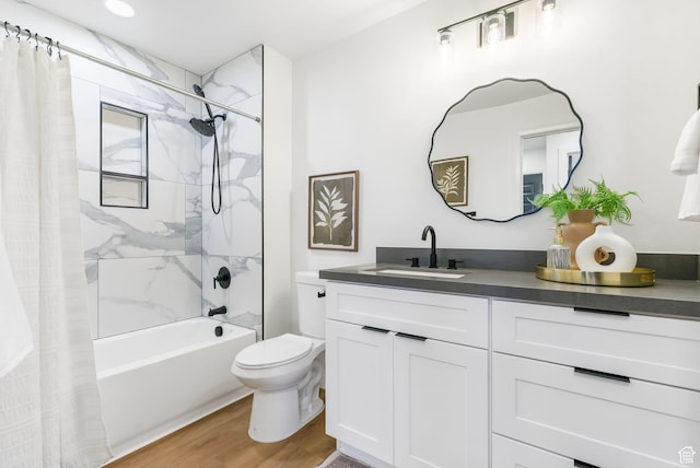 full bath featuring toilet, wood finished floors, shower / tub combo with curtain, and vanity