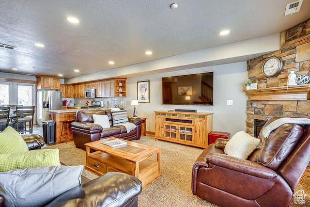 3518 N Moose Hollow Dr, Eden, UT 84310 - living area featuring a textured ceiling, visible vents, recessed lighting, and light colored carpet