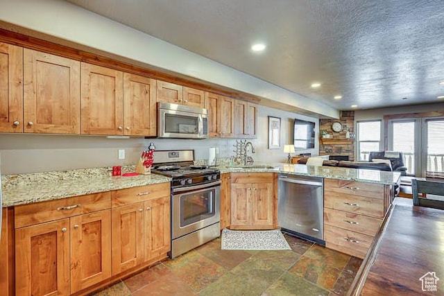 3518 N Moose Hollow Dr, Eden, UT 84310 - kitchen featuring a peninsula, recessed lighting, appliances with stainless steel finishes, a sink, and open floor plan