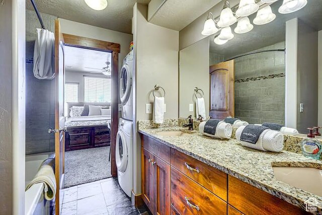 3518 N Moose Hollow Dr, Eden, UT 84310 - ensuite bathroom featuring stacked washer and dryer, double vanity, ensuite bathroom, and a sink