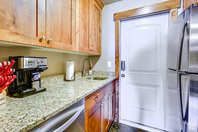 3518 N Moose Hollow Dr, Eden, UT 84310 - kitchen with a sink, light stone counters, brown cabinets, and appliances with stainless steel finishes