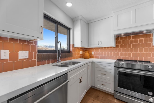 245 N Vine St W Unit 903, Salt Lake City, UT 84103 - kitchen with backsplash, white cabinets, a sink, and stainless steel appliances