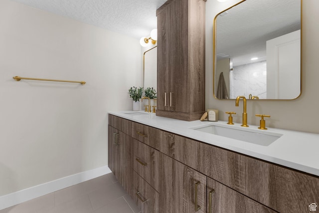 245 N Vine St W Unit 903, Salt Lake City, UT 84103 - bathroom featuring double vanity, tile patterned flooring, a sink, and a textured ceiling