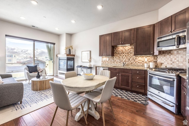 6169 Park S Unit 20, Park City, UT 84098 - kitchen with dark brown cabinets, a sink, appliances with stainless steel finishes, and dark wood-style floors