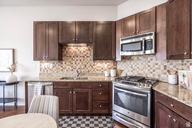 6169 Park S Unit 20, Park City, UT 84098 - kitchen featuring decorative backsplash, dark brown cabinetry, a sink, and appliances with stainless steel finishes