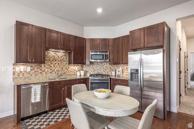 6169 Park S Unit 20, Park City, UT 84098 - kitchen featuring dark brown cabinets, decorative backsplash, a sink, and stainless steel appliances
