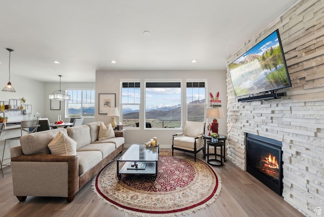 6065 N Westridge Rd, Heber City, UT 84032 - living area with recessed lighting, a stone fireplace, and wood finished floors