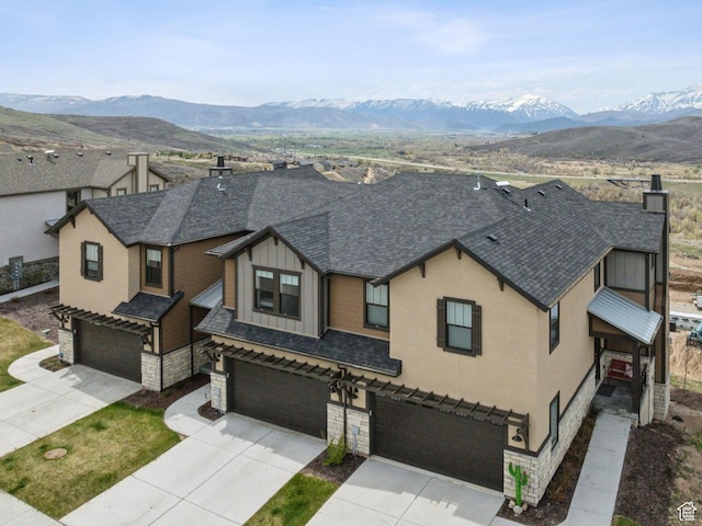 6065 N Westridge Rd, Heber City, UT 84032 - view of front of home featuring board and batten siding, an attached garage, driveway, and a shingled roof