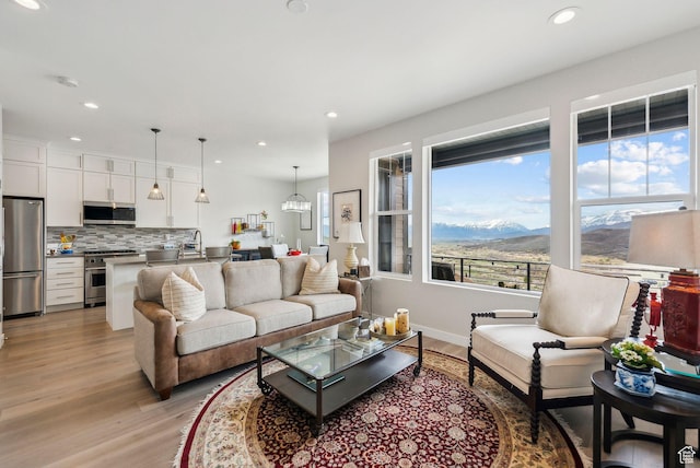 6065 N Westridge Rd, Heber City, UT 84032 - living area featuring recessed lighting, baseboards, light wood finished floors, and a mountain view