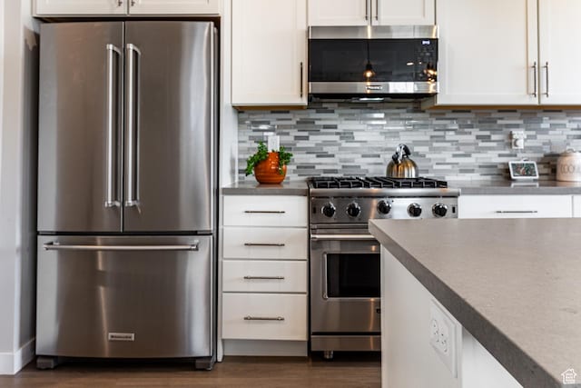 6065 N Westridge Rd, Heber City, UT 84032 - kitchen featuring dark countertops, stainless steel appliances, white cabinetry, decorative backsplash, and dark wood-style floors