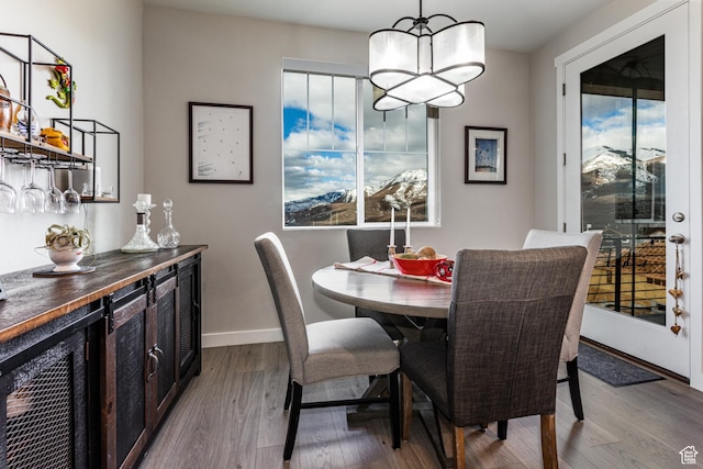 6065 N Westridge Rd, Heber City, UT 84032 - dining room featuring baseboards, a chandelier, a healthy amount of sunlight, and dark wood-type flooring