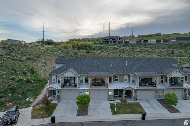 1089 W Cattail Ct, Kamas, UT 84036 - view of property featuring a balcony, driveway, a garage, stone siding, and roof with shingles