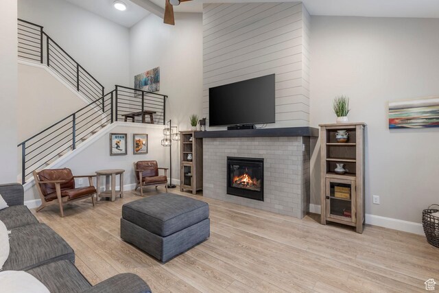 1089 W Cattail Ct, Kamas, UT 84036 - living room with a glass covered fireplace, wood finished floors, stairs, high vaulted ceiling, and baseboards