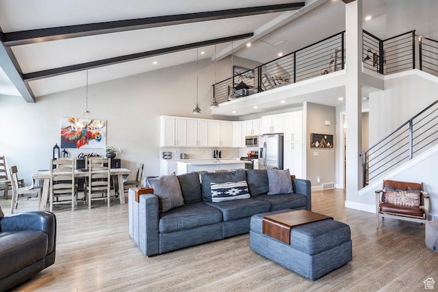 1089 W Cattail Ct, Kamas, UT 84036 - living room featuring light wood finished floors, beam ceiling, stairway, and high vaulted ceiling