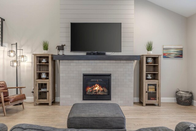 1089 W Cattail Ct, Kamas, UT 84036 - living room featuring wood finished floors, a brick fireplace, baseboards, and lofted ceiling