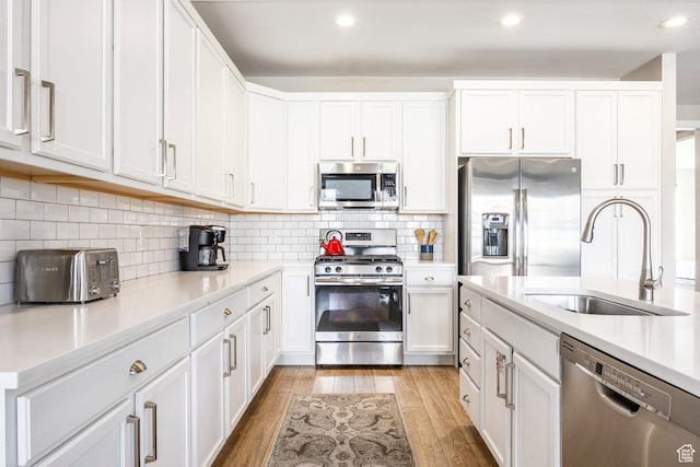 1089 W Cattail Ct, Kamas, UT 84036 - kitchen featuring light wood-style flooring, a sink, light countertops, white cabinets, and appliances with stainless steel finishes