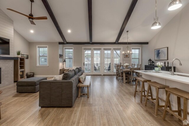 1089 W Cattail Ct, Kamas, UT 84036 - living room featuring light wood-style flooring, a fireplace, a chandelier, ceiling fan, and recessed lighting