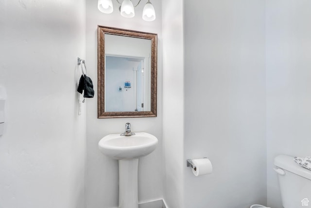 half bathroom featuring toilet