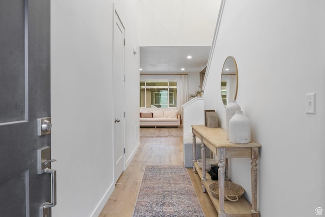 corridor with light wood-style floors and recessed lighting