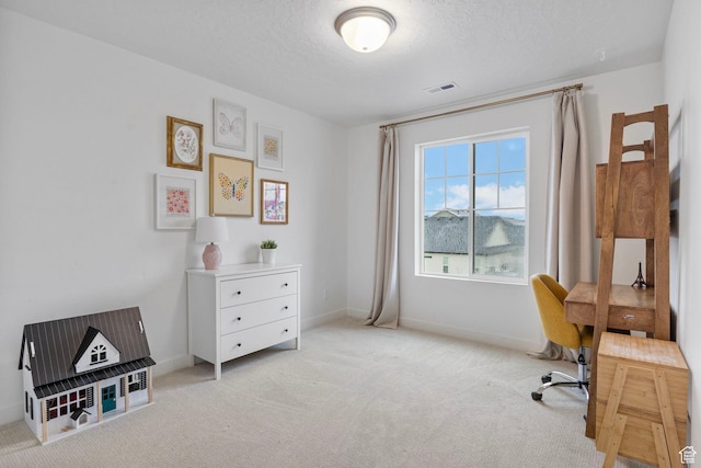 office space featuring visible vents, carpet, baseboards, and a textured ceiling