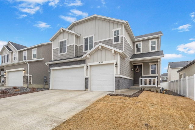 view of front of home with fence, an attached garage, board and batten siding, driveway, and a porch