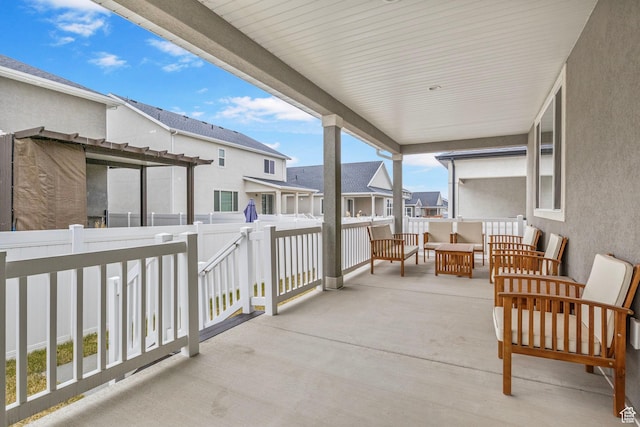 view of patio / terrace featuring a residential view, fence, and an outdoor living space