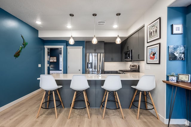 1376 Village Green Trl, Park City, UT 84098 - kitchen featuring light countertops, light wood finished floors, visible vents, and appliances with stainless steel finishes