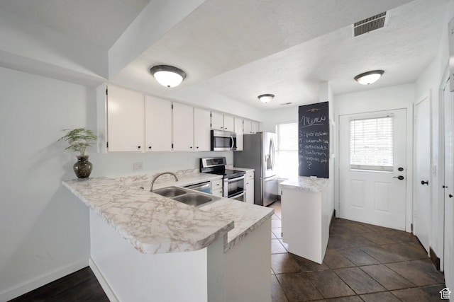 1418 W Telegraph Hill Dr, Taylorsville, UT 84123 - kitchen with light countertops, visible vents, a peninsula, stainless steel appliances, and a sink