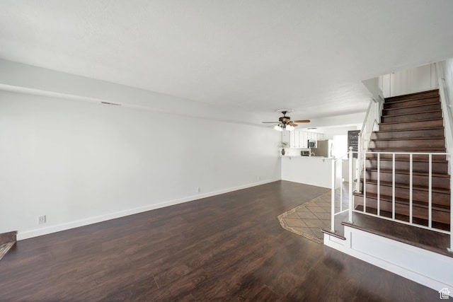 1418 W Telegraph Hill Dr, Taylorsville, UT 84123 - unfurnished living room featuring a ceiling fan, dark wood-type flooring, stairway, and baseboards