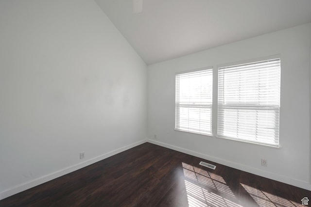 1418 W Telegraph Hill Dr, Taylorsville, UT 84123 - unfurnished room featuring baseboards, dark wood-style floors, visible vents, and vaulted ceiling