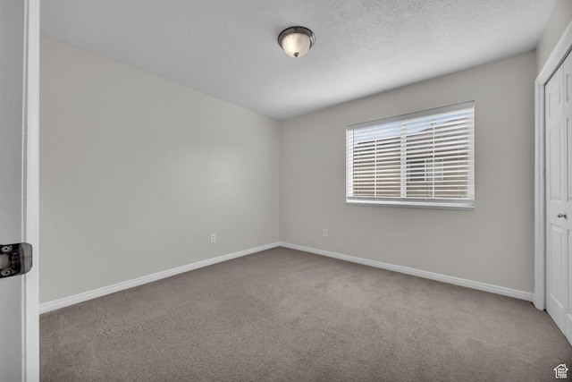 1598 Westbury Way Unit H, Lehi, UT 84043 - unfurnished bedroom featuring baseboards, a closet, carpet floors, and a textured ceiling