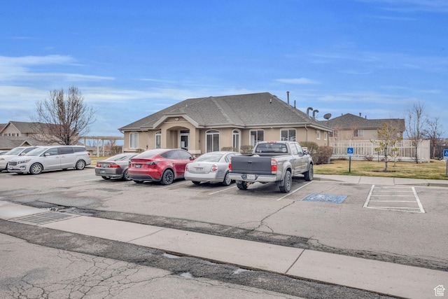 1598 Westbury Way Unit H, Lehi, UT 84043 - view of front of home featuring uncovered parking, fence, and roof with shingles