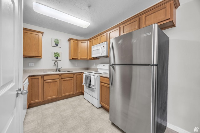 1598 Westbury Way Unit H, Lehi, UT 84043 - kitchen with light countertops, a sink, light floors, brown cabinets, and white appliances