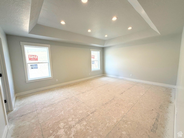 572 S Windy Ridge Dr E Unit 1207, Smithfield, UT 84335 - spare room featuring a tray ceiling, a textured ceiling, baseboards, and recessed lighting