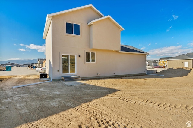 2398 E Cinder Ln, Eagle Mountain, UT 84005 - rear view of property with a patio, entry steps, and stucco siding