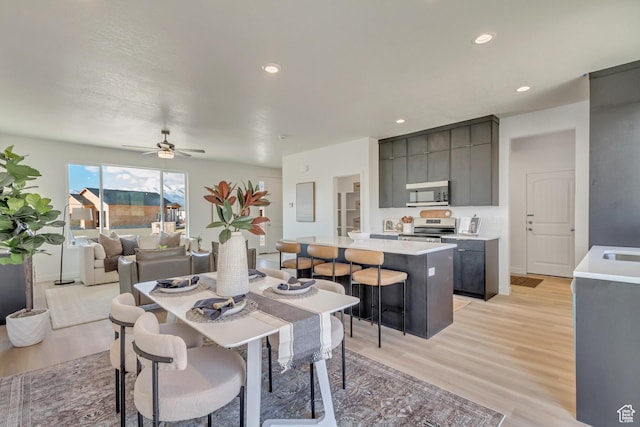 2398 E Cinder Ln, Eagle Mountain, UT 84005 - dining area featuring light wood-style flooring, ceiling fan, and recessed lighting