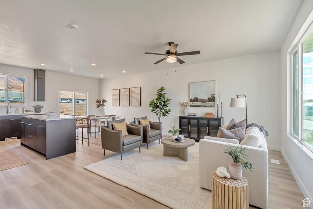 2398 E Cinder Ln, Eagle Mountain, UT 84005 - living area with light wood finished floors, a ceiling fan, and plenty of natural light