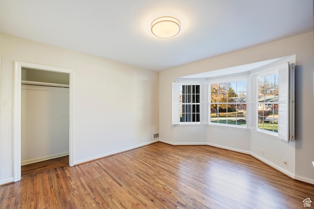 2532 E Maywood Dr, Salt Lake City, UT 84109 - unfurnished bedroom featuring baseboards, visible vents, a closet, and wood finished floors