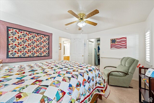 180 N 1100 E Unit 24, Washington, UT 84780 - carpeted bedroom with connected bathroom, a closet, and ceiling fan