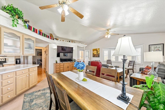 180 N 1100 E Unit 24, Washington, UT 84780 - dining area featuring light colored carpet, a ceiling fan, vaulted ceiling, and a textured ceiling