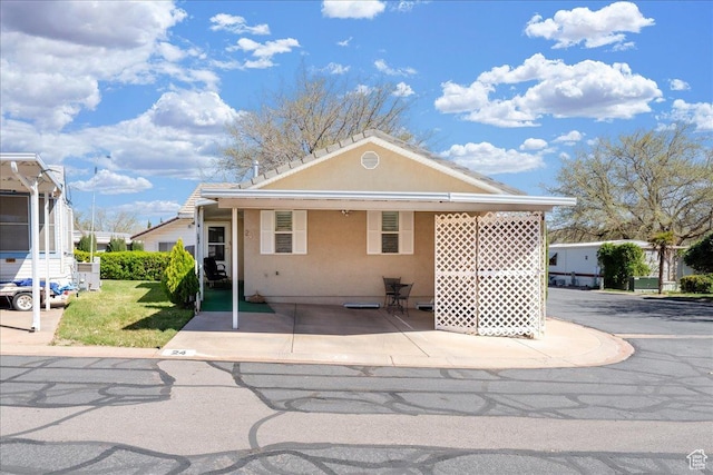 180 N 1100 E Unit 24, Washington, UT 84780 - view of front of house with a front yard and stucco siding
