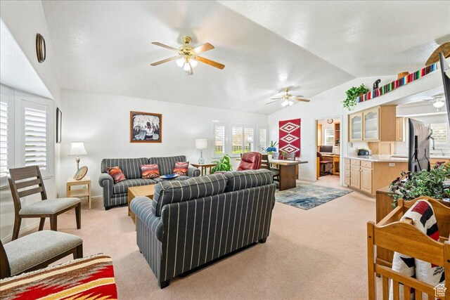 180 N 1100 E Unit 24, Washington, UT 84780 - living room with a ceiling fan, light carpet, a textured ceiling, lofted ceiling, and baseboards