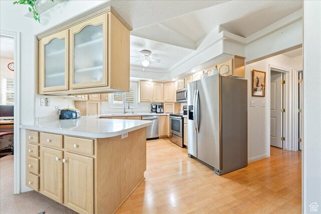 180 N 1100 E Unit 24, Washington, UT 84780 - kitchen with light countertops, a ceiling fan, light brown cabinetry, a peninsula, and stainless steel appliances