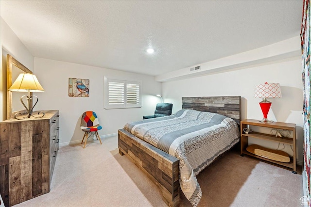 180 N 1100 E Unit 24, Washington, UT 84780 - bedroom featuring baseboards, a textured ceiling, visible vents, and light colored carpet