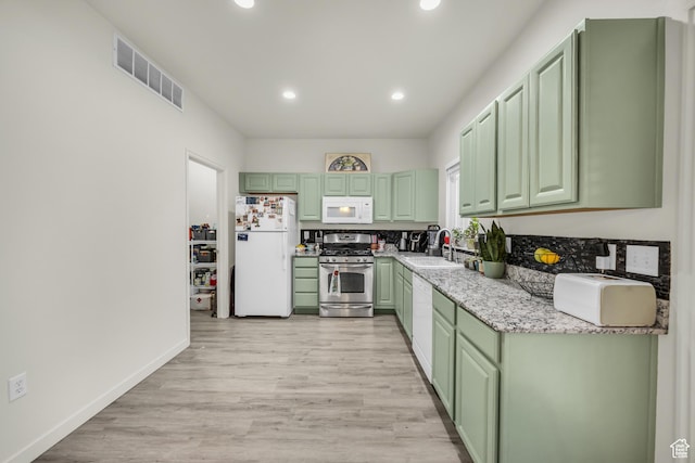 5116 W Rock Butte Rd, Herriman, UT 84096 - kitchen with visible vents, light wood-style flooring, white appliances, a sink, and green cabinetry