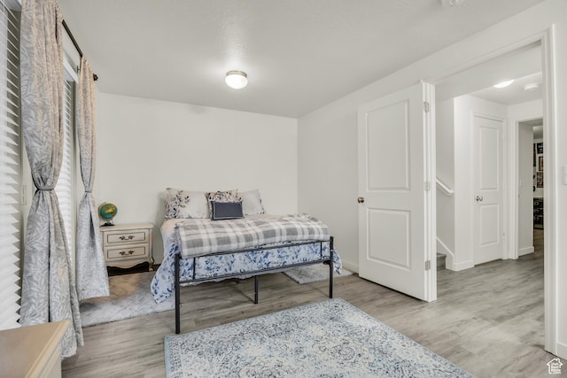 5116 W Rock Butte Rd, Herriman, UT 84096 - bedroom with baseboards and wood finished floors