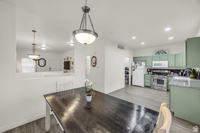 5116 W Rock Butte Rd, Herriman, UT 84096 - dining room with recessed lighting, baseboards, and light wood-type flooring