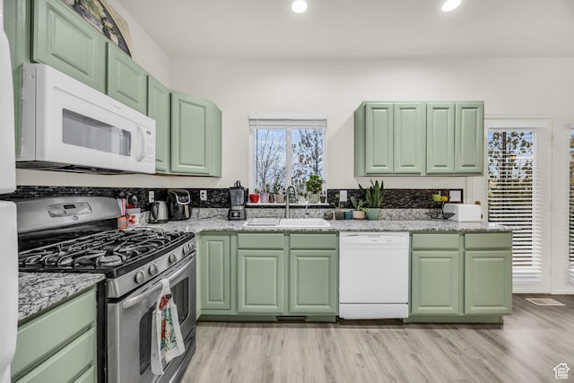 5116 W Rock Butte Rd, Herriman, UT 84096 - kitchen featuring green cabinets, a sink, light wood-style floors, and white appliances