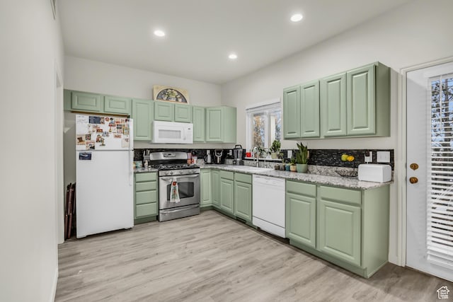 5116 W Rock Butte Rd, Herriman, UT 84096 - kitchen with green cabinets, white appliances, light wood finished floors, and a sink