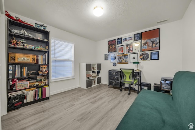 5116 W Rock Butte Rd, Herriman, UT 84096 - home office with baseboards, a textured ceiling, visible vents, and wood finished floors